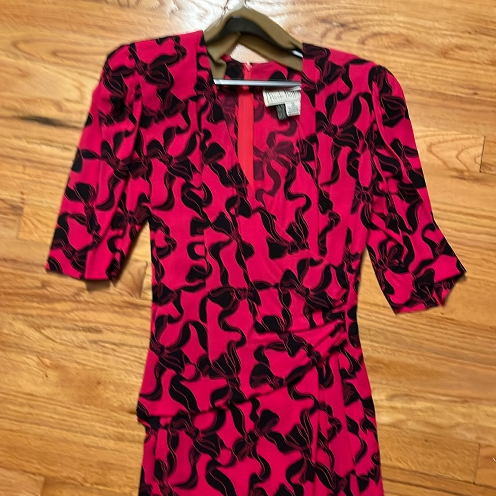 Nicole Miller dress.  Pink with black bow pattern.  Faux wrap.  - size 6